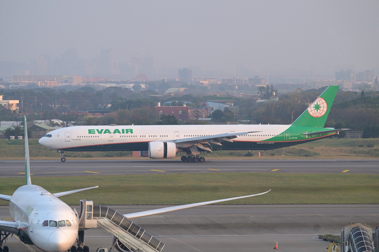 An EVA Air Boeing 777-300ER, the airline Chang Yung-fa founded in 1989, landing at Taiwan Taoyuan International Airport in February 2026