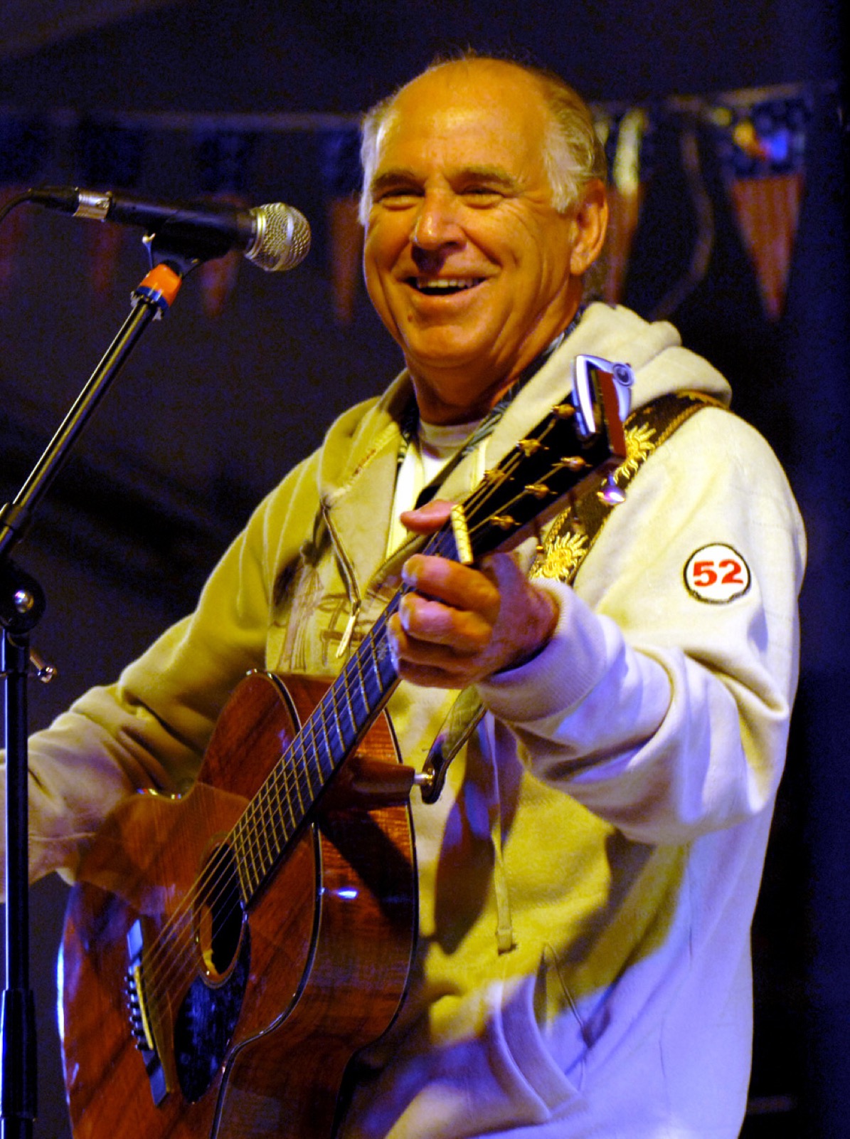 Jimmy Buffett, guitar in hand, performing a USO concert for the crew of USS Harry S. Truman in a Middle Eastern port on 28 January 2008