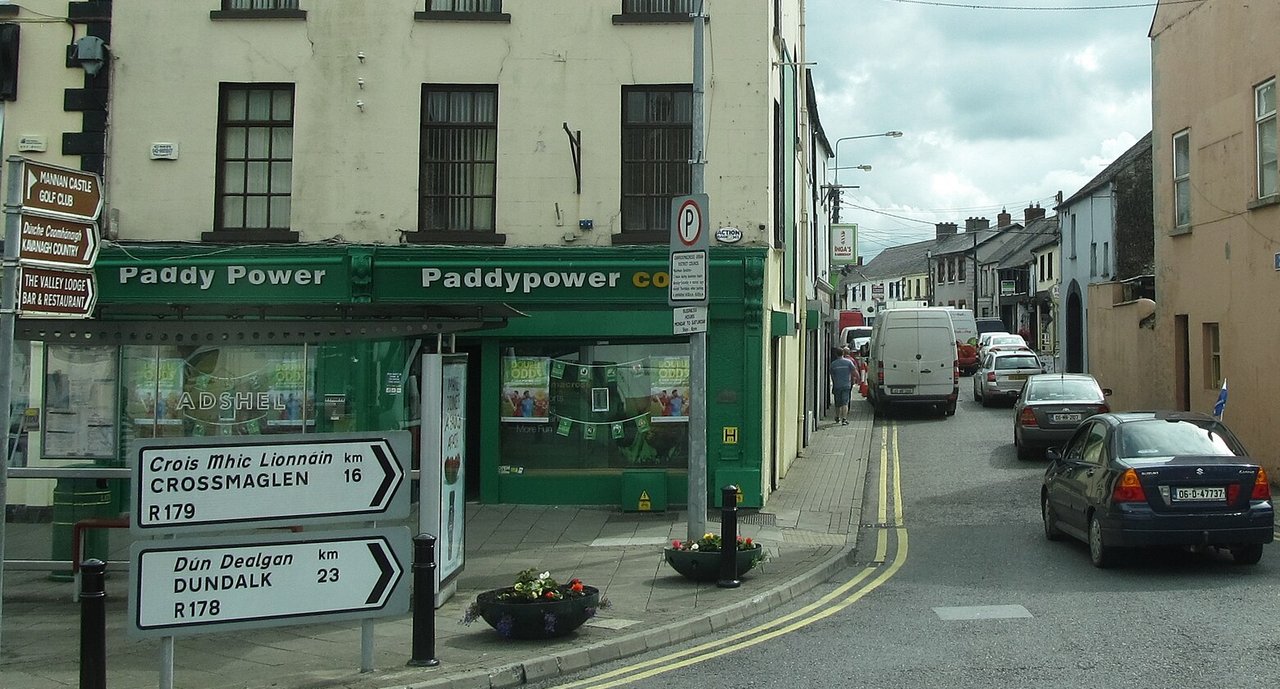 A Paddy Power betting shop with its green shopfront on a street corner in Carrickmacross, County Monaghan, Ireland. Sabena Power, widow of the Paddy Power co-founder, left an estate valued at more than €861 million